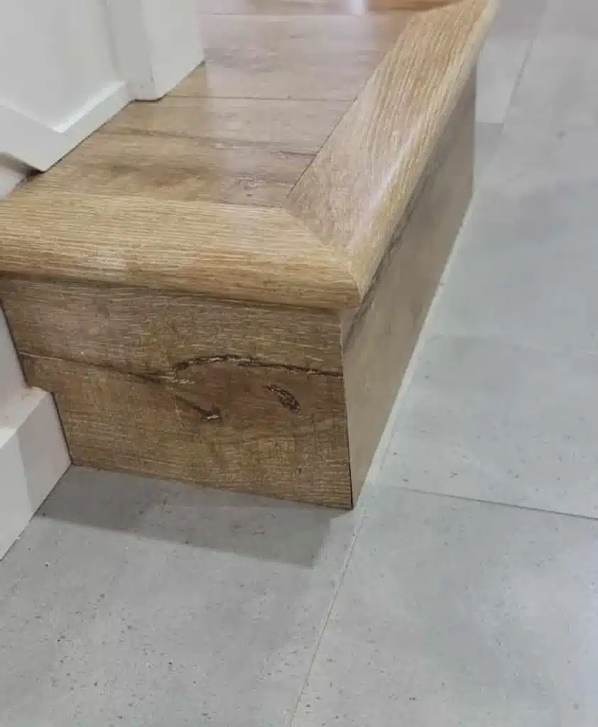 After image of a laminate step edge with the corner expertly repaired, showing no visible damage.