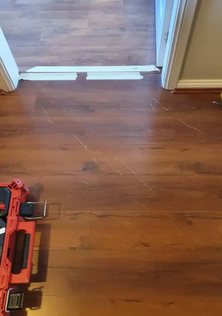 Before image showing scratches on a laminate floor