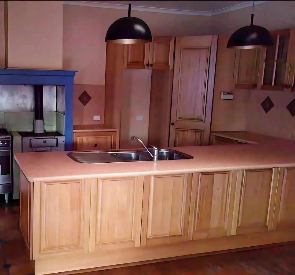 Bright and spacious kitchen with a resurfaced benchtop and gold accents.