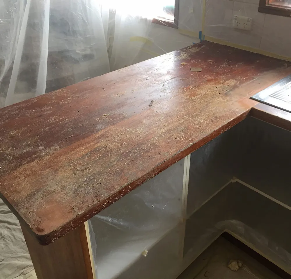 Kitchen benchtop showing wear and damage before resurfacing