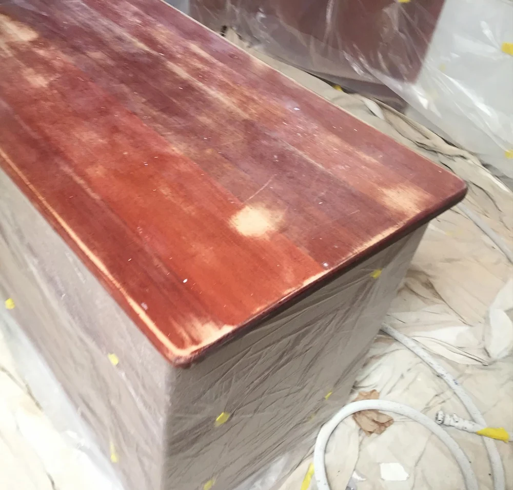 Before image of a worn wooden kitchen benchtop before resurfacing.