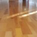 Polished wooden floor with a glossy finish.