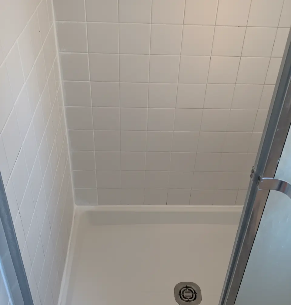 Shower with clean, fresh grout lines and bright tiles after professional regrouting by Surface Care