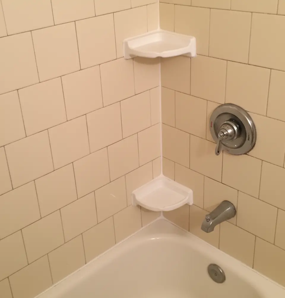 Shower wall with clean, fresh grout after regrouting by Surface Care