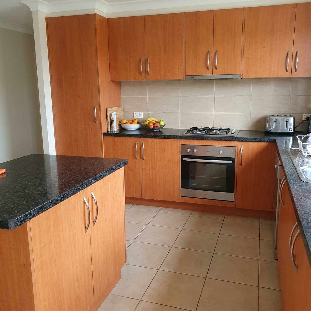 Dated timber-look laminate kitchen cabinets before respray (colour visualisation)