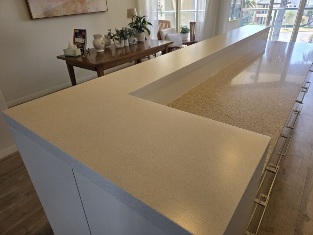 Same benchtop after full spray resurfacing to a cream stone-look finish, Port Melbourne