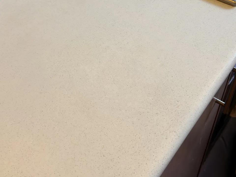 The same laminate benchtop after both burns were filled, the speckle pattern painted back in and sealed