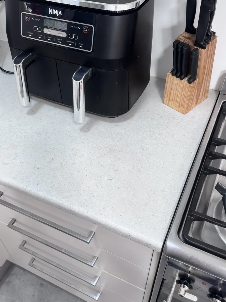 The same benchtop after the burn was repaired and the stone pattern matched